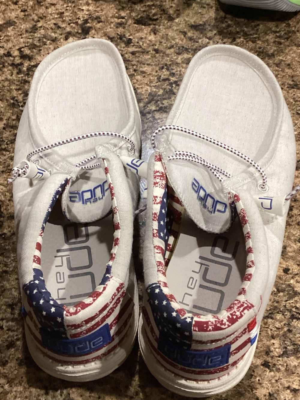 Hey Dude Kids White Slip-On Sneakers with Red and Blue Flag Accent